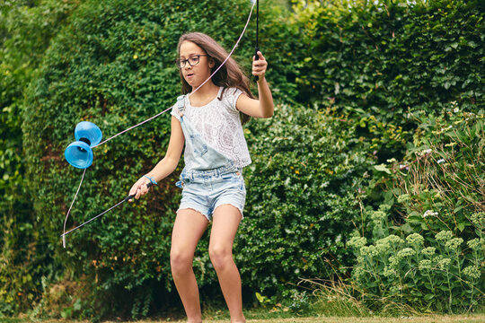  Girl playing with diabolo in garden