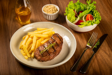 Grilled steak with french fries, brazilian farofa and salad.