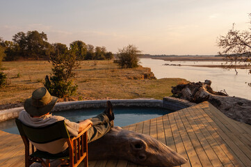 Traveller relaxing at Kalamu Tented Camp, South Luangwa National Park, Zambia