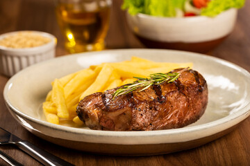 Grilled steak with french fries, brazilian farofa and salad.