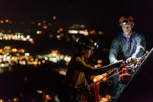Two men trad climbing at night, Squamish, British Columbia, Canada