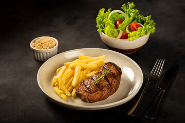 Grilled steak with french fries, brazilian farofa and salad.