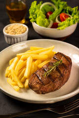 Grilled steak with french fries, brazilian farofa and salad.