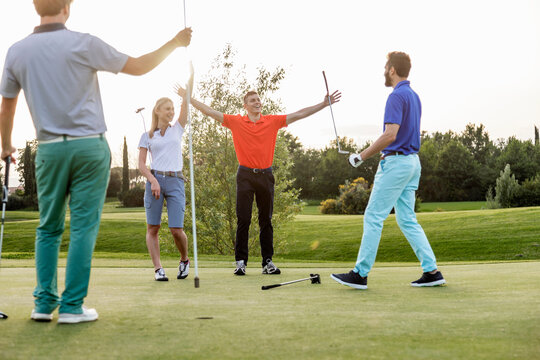 Friends playing golf on golf course