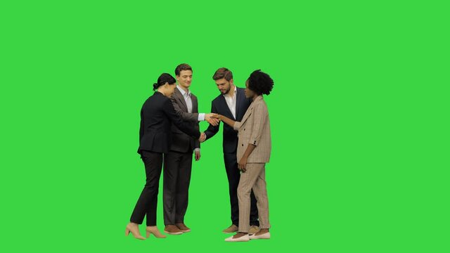 A business meeting, official meeting: partners meet, handshake and pose for a picture on a Green Screen, Chroma Key.