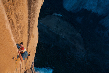 High angle view of mountaineer climbing up sheer wall of The Nose, El Capitan, Yosemite National Park. 