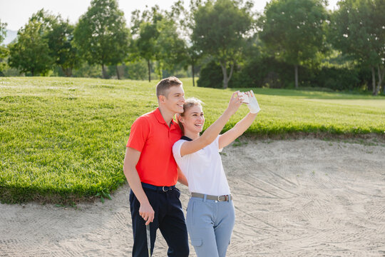 Couple taking selfie on golf course