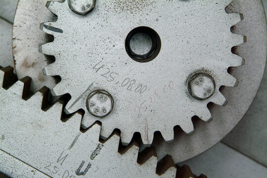 Close up of old wooden cogwheel in abandoned factory.