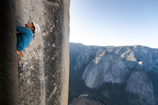 Mountaineer climbing up sheer wall of The Nose, El Capitan, Yosemite National Park. 