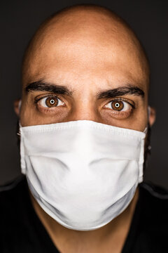 A Man Wearing A Face Mask Covering His Nose And Mouth. 