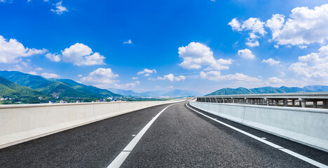 Fototapeta premium country road and green mountains in summer.