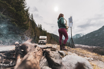 Woman standing on a mountain in the Squamish Valley, British Columbia, Canada, playing the saxophone.