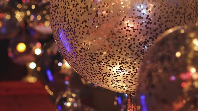 Decoration interior elements of restaurant venue banquet hall with multicoloured different helium balloons, on a indoor corporate event or wedding reception or birthday party celebration