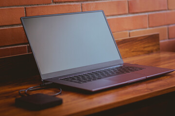 laptop with 2021 design on a wooden table