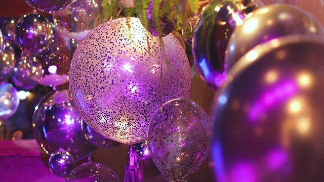 Decoration interior elements of restaurant venue banquet hall with multicoloured different helium balloons, on a indoor corporate event or wedding reception or birthday party celebration
