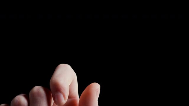 Vertical Close up of male hand flipping white poker chip with black background shot in 4k super slow motion