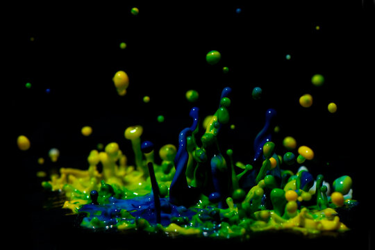 Paint Sculpture - High speed photography of splashes of green, yellow and blue paint.