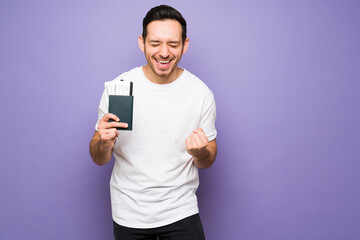 Man shouting with excitement and holding a plane ticket