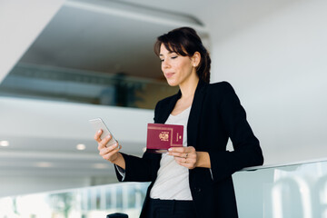 Businesswoman using mobile phone for electronic check-in