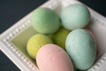 Fototapeta na wymiar Colorful Easter eggs in a square, white bowl. 