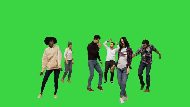 Flashmob: young people walk in and start dancing on a Green Screen, Chroma Key.