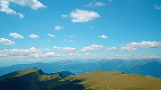 Panorama of Italian Dolomites in autumn, time-lapse, white clouds floating in blue sky