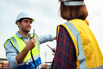 Engineers working on railway train statation and holding walkie talkie for plan and meeting. Portrait of professional leadership of engineering teamwork. Warehouse and successful concept. 