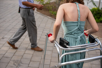 Rear view of woman using posture control walker