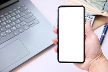 hand holding phone with tablet