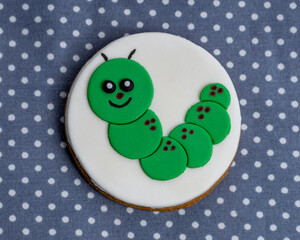 One caterpillar design iced cookie on a polka dot table cloth