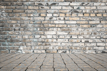 Empty room with bricks wall and tiled floor.