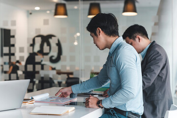 Side view of asian businessman working together in the office.