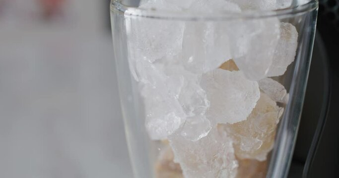 Coffee from machine to the ice in glass
