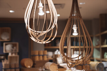 Illuminated hand made hanging wooden lamps. Bohemian, boho style, neutral  brown earthy tones photo