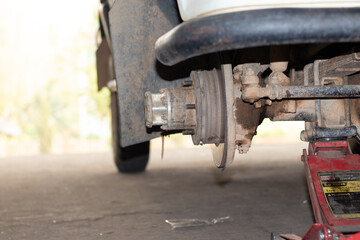 The mechanic is checking the engine.