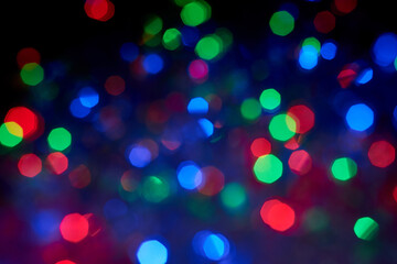 Blurred background, multicolored Christmas, New Year garland out of focus.