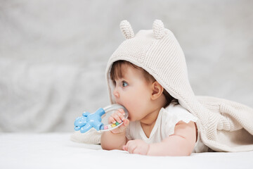 Baby girl in a hoodie sweatshirt playing with toy