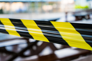 Black and yellow lines of barrier tape forbids passage. Concept of No entry.