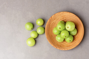 Indian Gooseberry or phyllanthus emblica fruits on ceramic background.top view,flat lay.