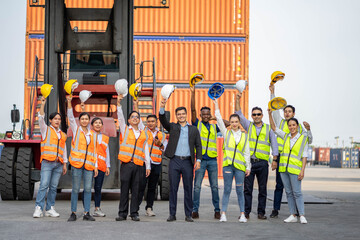 Group of employees and management team wearing logistic uniforms and stand to celebrating or raise their hands together for exporting products abroad. Finishing successful.