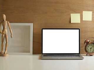 Workspace with laptop and decorations in home office room