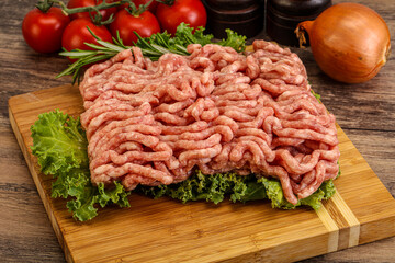 Raw pork minced meat over board