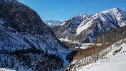 Valley among Sayan Mountains with Frozen Water Surface in Winter. Irkut River Covered with Ice and Snow, Russia