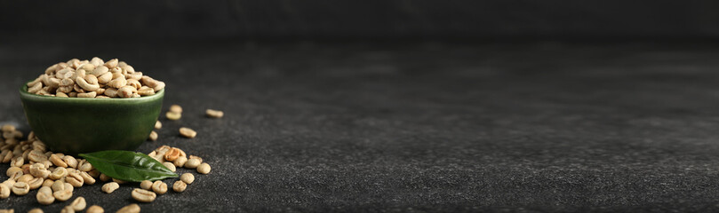 Bowl of coffee beans on dark background with space for text