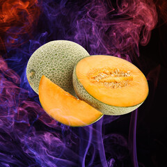 Fresh melon and color smoke on dark background