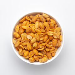 Close up of Crunchy masala peanuts Indian namkeen (snacks) on a ceramic white bowl. Top view