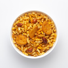 Close up of very spicy sweet Fatafat Bhel mixture Indian namkeen (snacks) on a ceramic white bowl. Top view