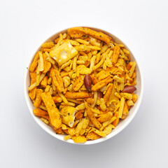 Close up of salted Gujrati Mix  Indian namkeen (snacks) on a ceramic white bowl. Top view