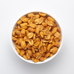 Close up of Heeng jeera Peanuts mixture Indian namkeen (snacks) on a ceramic white bowl. Top view