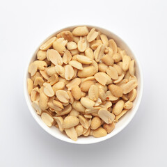 Close up of Salted Peanuts Indian namkeen (snacks) on a ceramic white bowl. Top view
